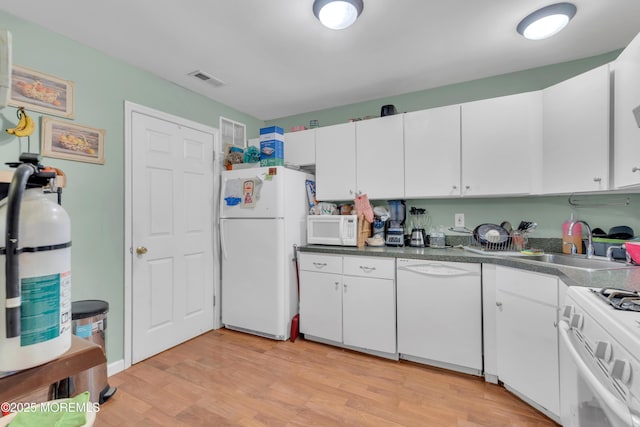 707 Zlotkin Cir Unit 7, Freehold, NJ 07728 - kitchen featuring white appliances, a sink, light wood-style floors, and white cabinets