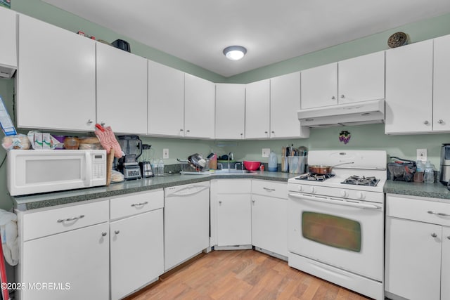 707 Zlotkin Cir Unit 7, Freehold, NJ 07728 - kitchen with white appliances, under cabinet range hood, light wood finished floors, a sink, and white cabinetry