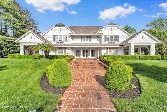 view of front of house featuring a front lawn and french doors