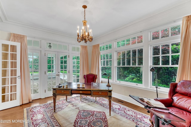 office area with french doors, a chandelier, ornamental molding, and wood finished floors