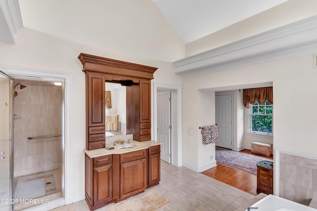 full bathroom featuring a stall shower, lofted ceiling, tile patterned floors, vanity, and a bath