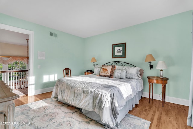 bedroom featuring baseboards and wood finished floors