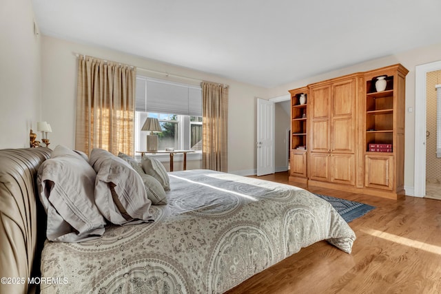 bedroom featuring wood finished floors and baseboards