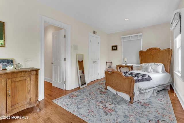 bedroom with light wood-style flooring, recessed lighting, and baseboards