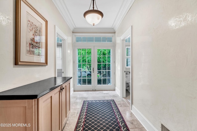 doorway to outside featuring french doors, ornamental molding, baseboards, and stone tile floors