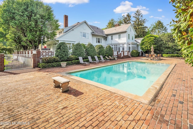 swimming pool featuring a patio area and fence