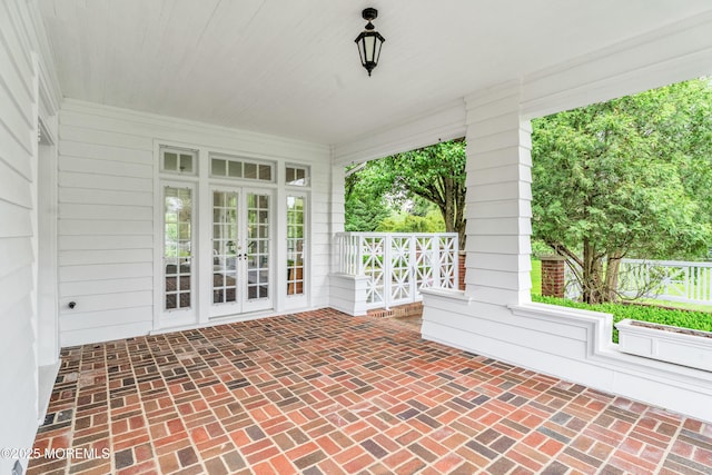 unfurnished sunroom featuring french doors