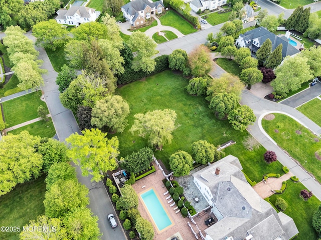 aerial perspective of suburban area featuring a pool