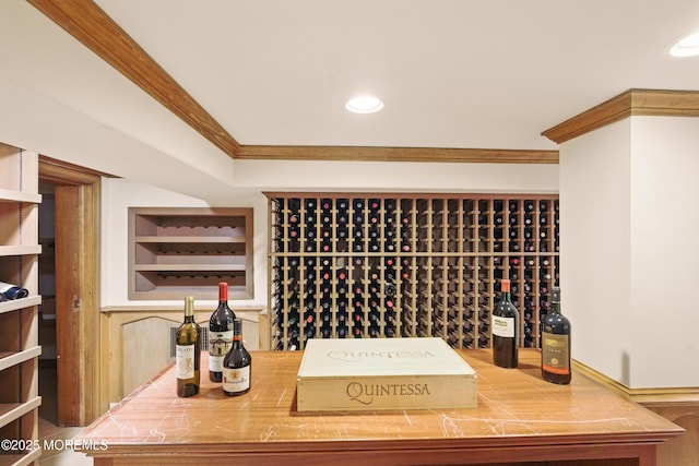 wine area with ornamental molding and recessed lighting