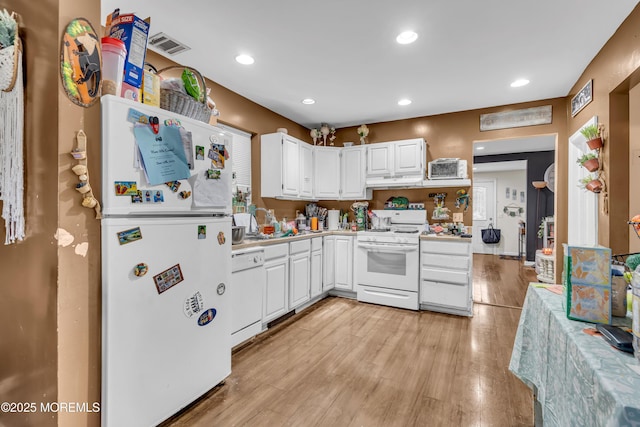 48 Bannard St, Freehold, NJ 07728 - kitchen with white appliances, light wood-style flooring, white cabinetry, light countertops, and recessed lighting