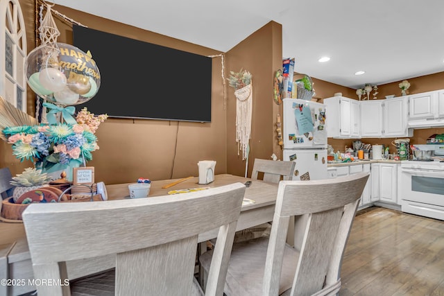 48 Bannard St, Freehold, NJ 07728 - kitchen with under cabinet range hood, white appliances, white cabinets, recessed lighting, and light wood-style floors