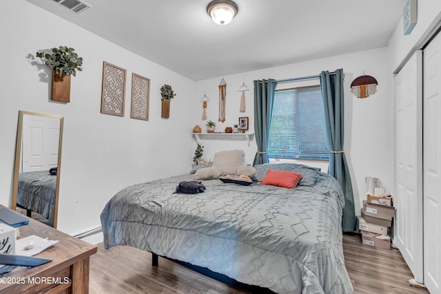 48 Bannard St, Freehold, NJ 07728 - bedroom featuring wood finished floors, a closet, and a baseboard heating unit