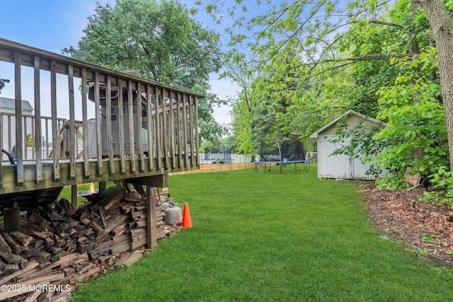 48 Bannard St, Freehold, NJ 07728 - view of grassy yard with a trampoline, a shed, an outdoor structure, and a deck