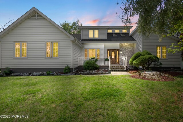 22 Cloverleaf Dr, Marlboro, NJ 07746 - view of front of home with a porch, a front yard, and stone siding