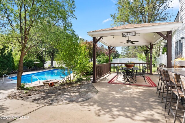 22 Cloverleaf Dr, Marlboro, NJ 07746 - view of swimming pool with ceiling fan, a fenced backyard, a gazebo, a patio area, and exterior bar