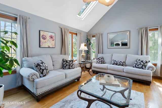 22 Cloverleaf Dr, Marlboro, NJ 07746 - living room featuring a skylight, plenty of natural light, high vaulted ceiling, and wood finished floors