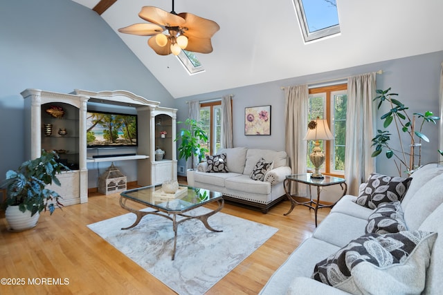 22 Cloverleaf Dr, Marlboro, NJ 07746 - living area featuring a skylight, high vaulted ceiling, a ceiling fan, and wood finished floors