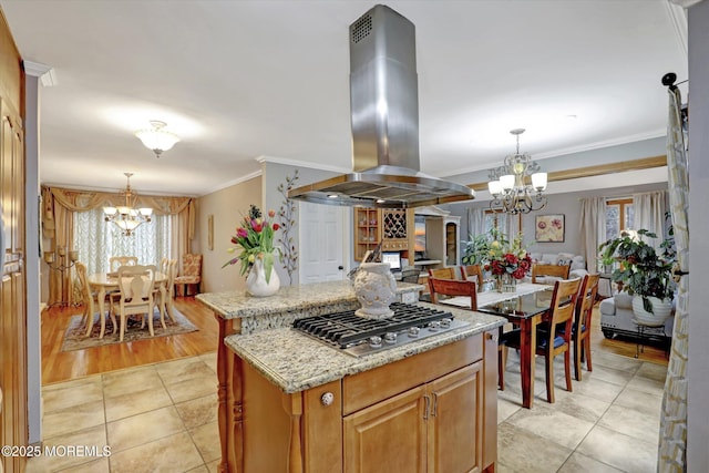 22 Cloverleaf Dr, Marlboro, NJ 07746 - kitchen featuring island range hood, a chandelier, stainless steel gas cooktop, crown molding, and a center island