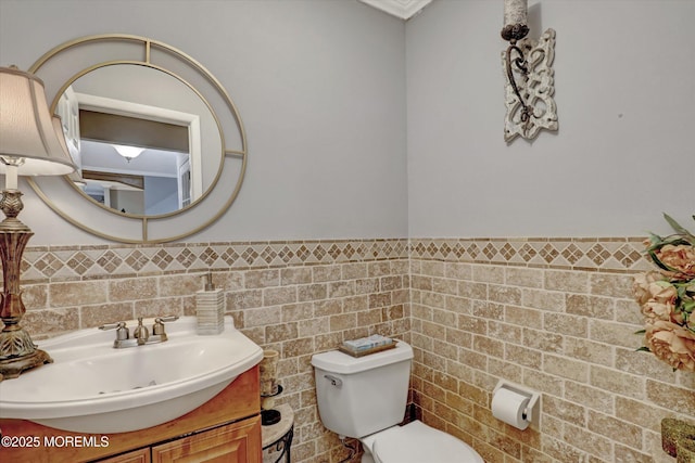 22 Cloverleaf Dr, Marlboro, NJ 07746 - half bathroom with toilet, vanity, tile walls, and a wainscoted wall