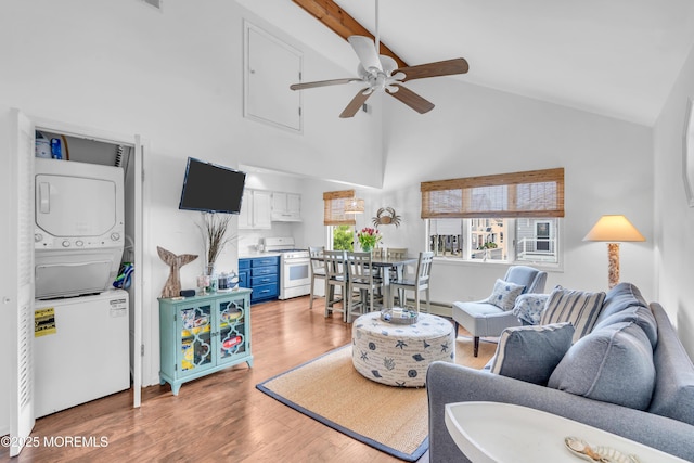 233 Harbor Dr, Lavallette, NJ 08735 - living room with stacked washer / drying machine, ceiling fan, high vaulted ceiling, light wood finished floors, and baseboard heating