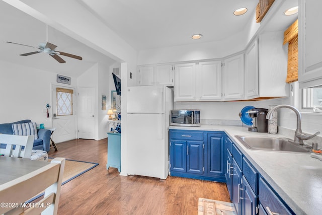 233 Harbor Dr, Lavallette, NJ 08735 - kitchen with a sink, freestanding refrigerator, blue cabinets, stainless steel microwave, and white cabinets