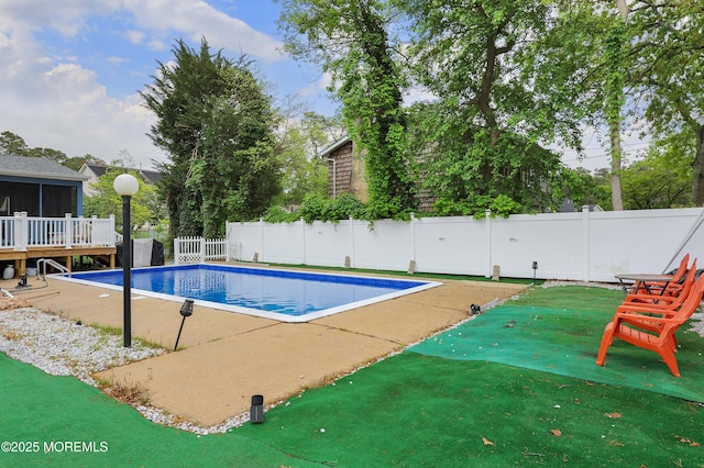 view of pool featuring a fenced backyard, a sunroom, and a patio