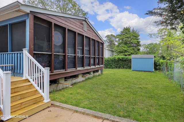 view of yard with a sunroom, a shed, and an outdoor structure