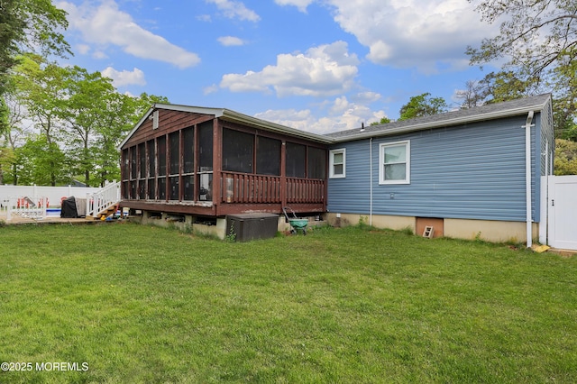 back of house featuring a sunroom and central AC