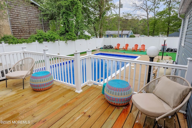 wooden terrace featuring a fenced backyard