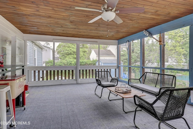 sunroom with a ceiling fan and plenty of natural light