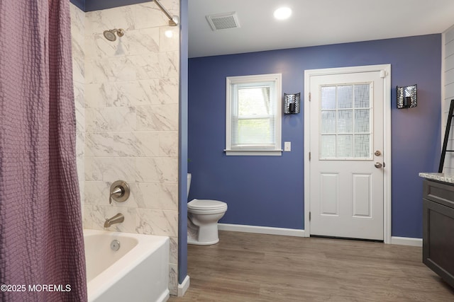 bathroom with wood finished floors, shower / tub combo, vanity, baseboards, and toilet