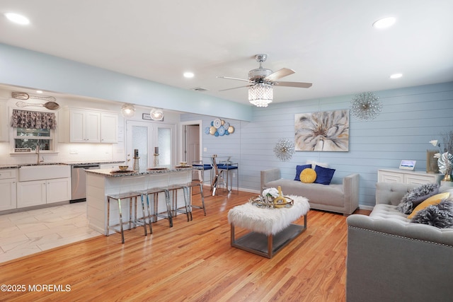 living area featuring a ceiling fan, light wood-style flooring, and recessed lighting