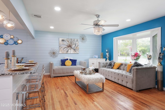 living area with wood finished floors, a ceiling fan, and recessed lighting