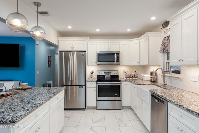 kitchen featuring appliances with stainless steel finishes, a sink, white cabinetry, light marble finish floors, and recessed lighting