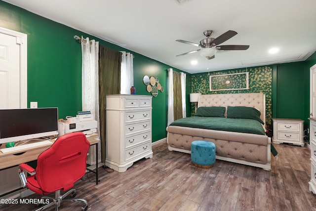 bedroom featuring wood finished floors, a desk, and ceiling fan