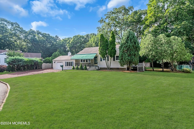 view of front of home featuring driveway, a front lawn, and a garage