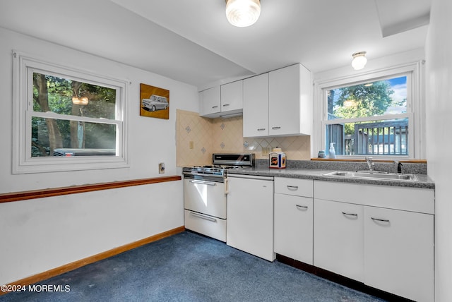 kitchen featuring white appliances, a sink, tasteful backsplash, white cabinetry, and dark countertops