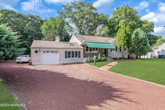 view of front facade with driveway, an attached garage, and a front yard