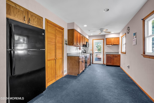 kitchen with freestanding refrigerator, brown cabinetry, ceiling fan, plenty of natural light, and recessed lighting