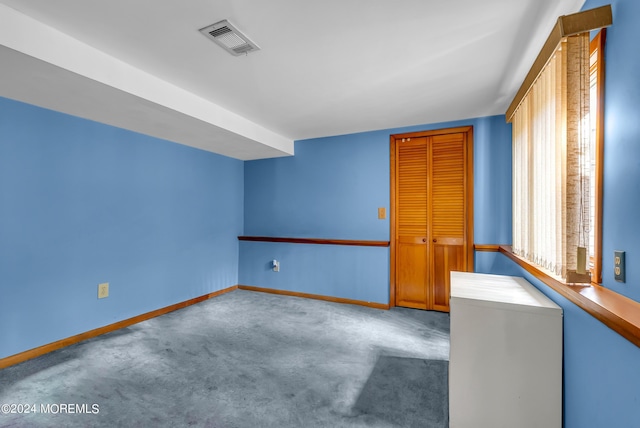 unfurnished room with baseboards and carpet floors