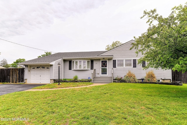 view of front of home featuring a garage, asphalt driveway, and roof with shingles