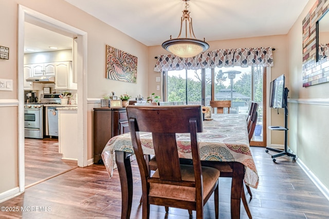 dining area featuring wood finished floors and baseboards