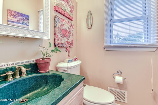 bathroom with toilet and vanity