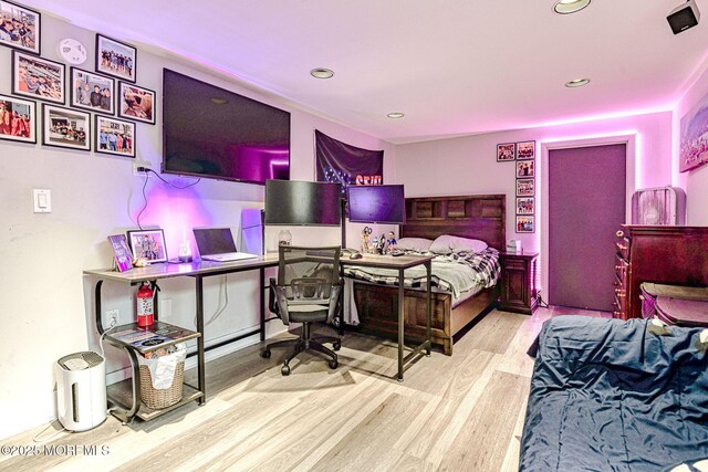 bedroom featuring wood finished floors, recessed lighting, and an office area