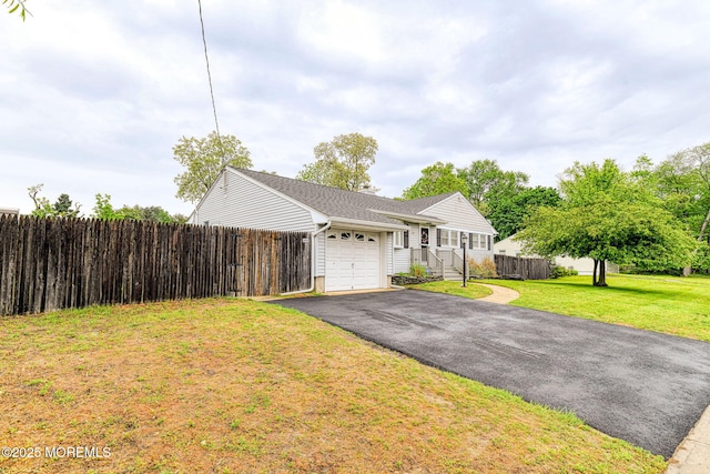 single story home with a garage and asphalt driveway