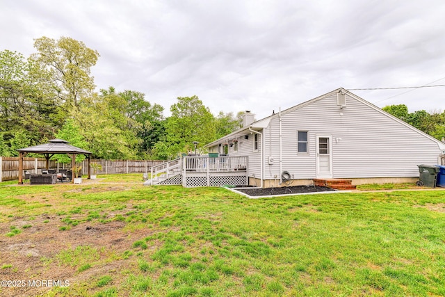 back of house featuring a gazebo, a chimney, and a wooden deck