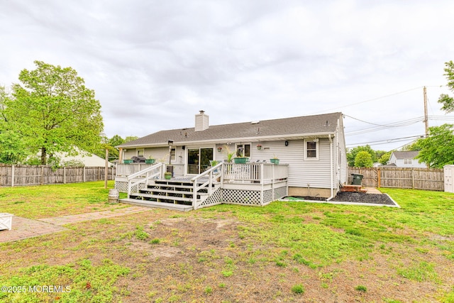 back of property with a deck, a chimney, a shed, and an outdoor structure