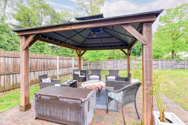 view of patio with an outdoor living space, a gazebo, and a fenced backyard