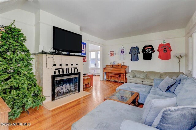 78 Navesink Ave, Highlands, NJ 07732 - living room featuring light wood finished floors and a brick fireplace