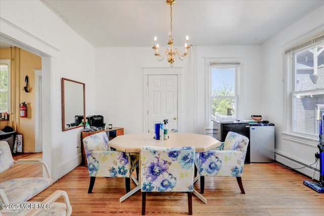 78 Navesink Ave, Highlands, NJ 07732 - dining room with a chandelier, a baseboard radiator, light wood-type flooring, and healthy amount of natural light